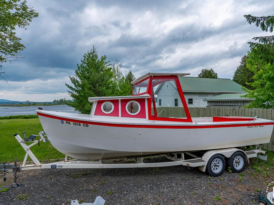 CampBassRockOnTupperLake_TugBoat_Side